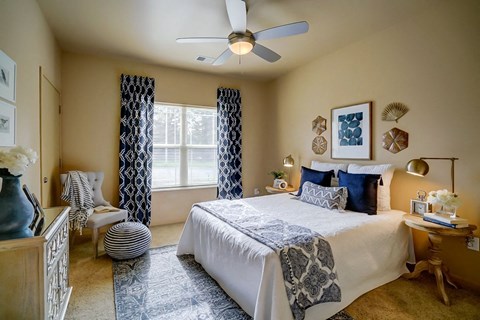 a bedroom with a bed and a ceiling fan