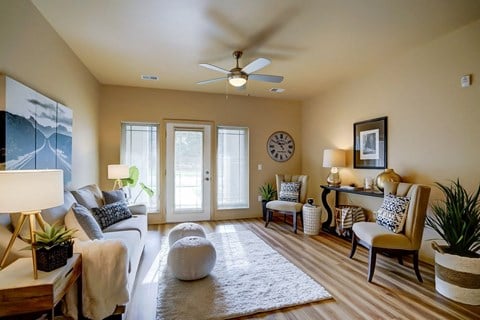 a living room with a couch and a ceiling fan