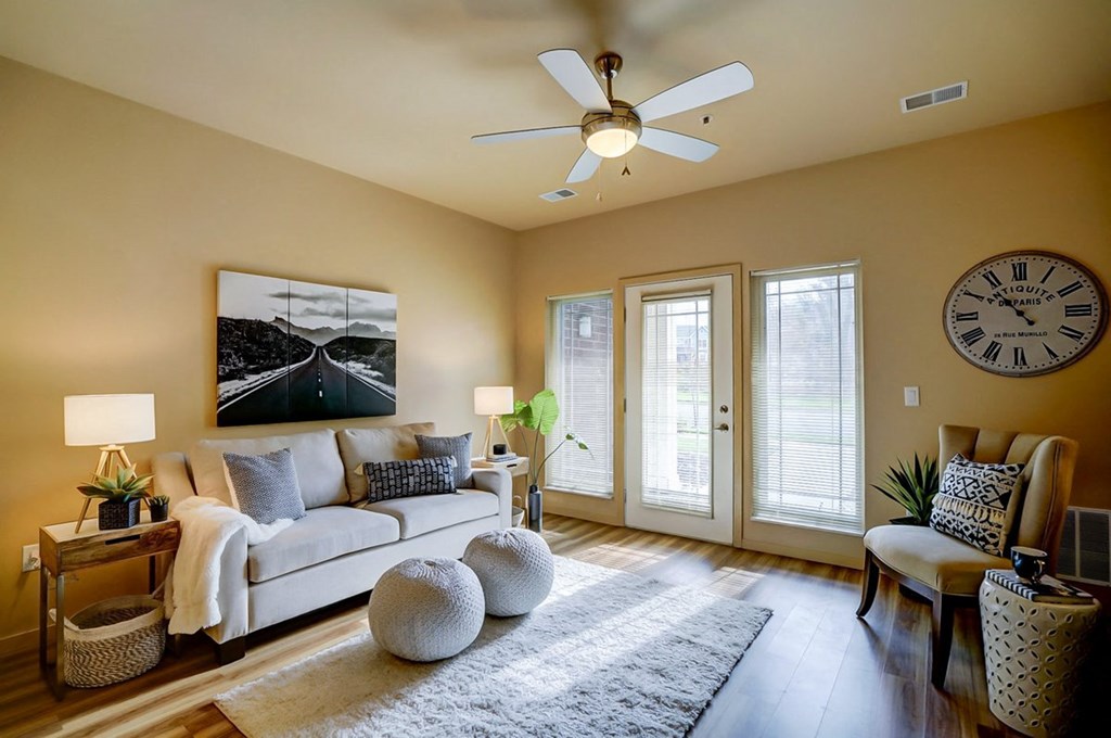 a living room with a couch and a ceiling fan