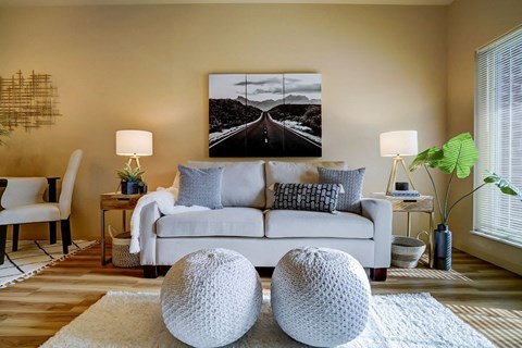 a living room with a couch and a picture on the wall