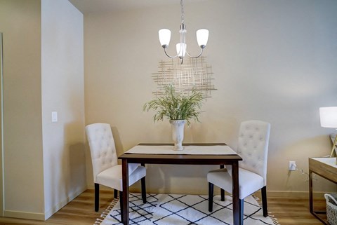 a dining room with a table and chairs and a chandelier