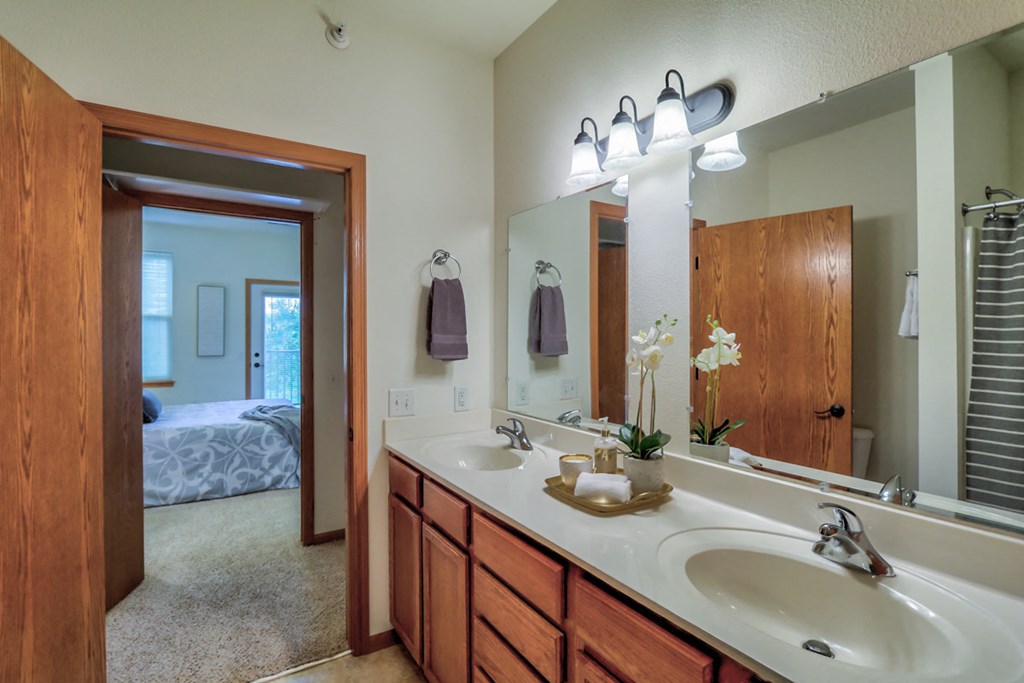 a bathroom with two sinks and a large mirror