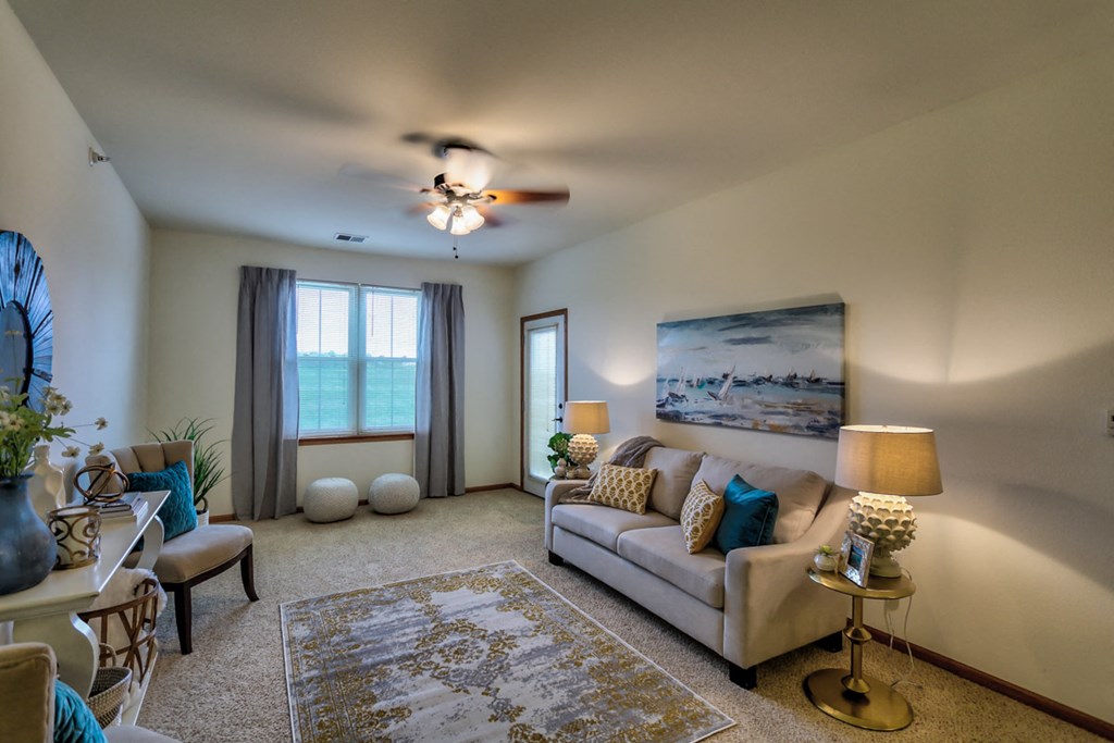 a living room with a couch and a ceiling fan