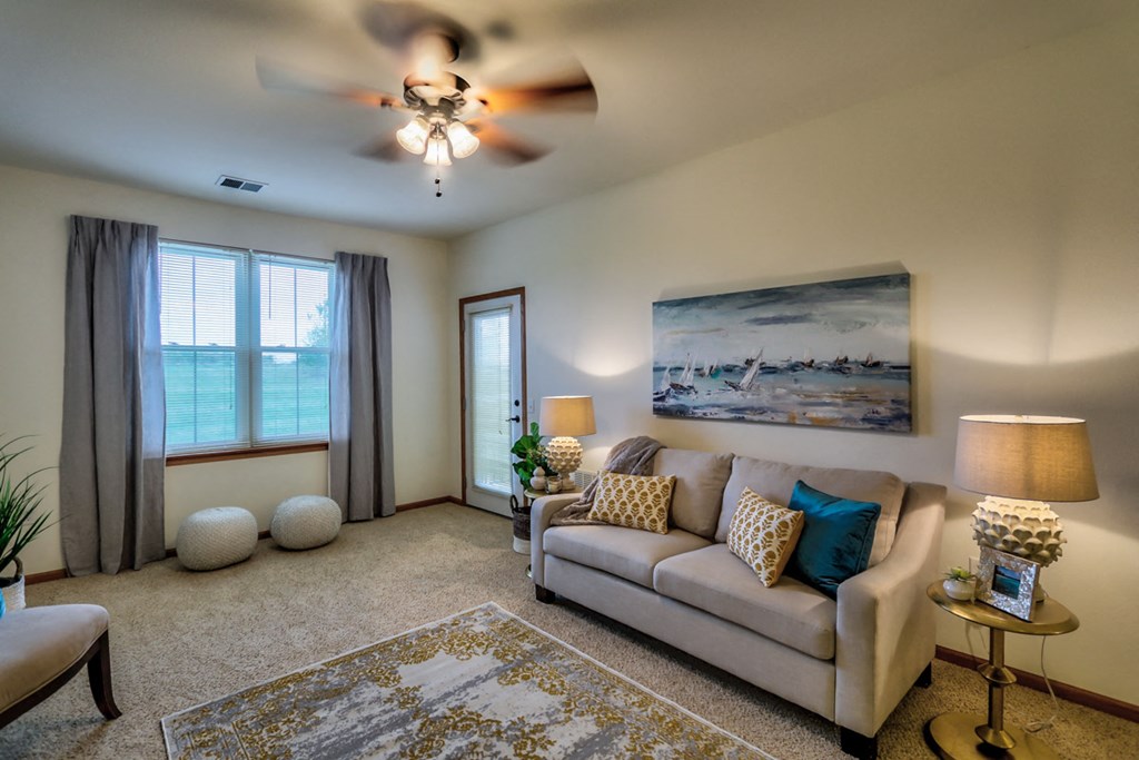 a living room with a couch and a ceiling fan