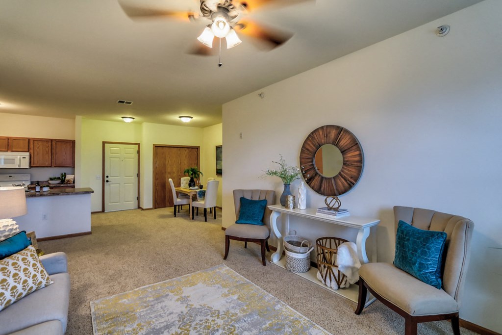 a living room with furniture and a ceiling fan