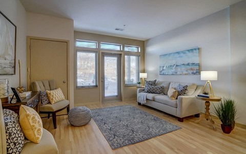 a living room with a couch and a door to a balcony
