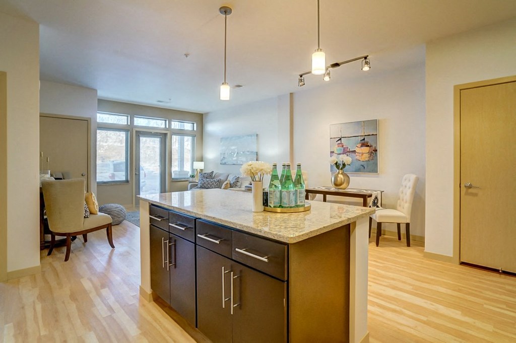 a kitchen with an island and a living room with a dining room
