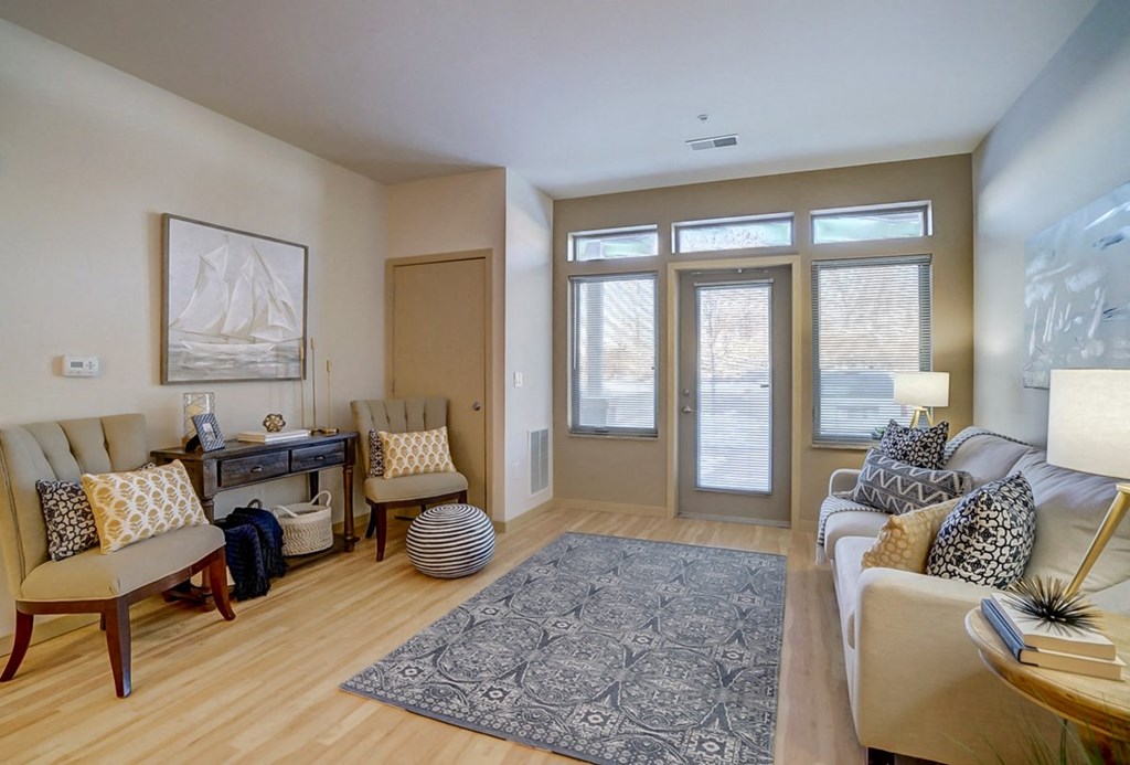 a living room with a couch and chairs and a rug