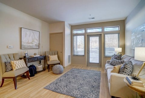 a living room with a couch and chairs and a rug