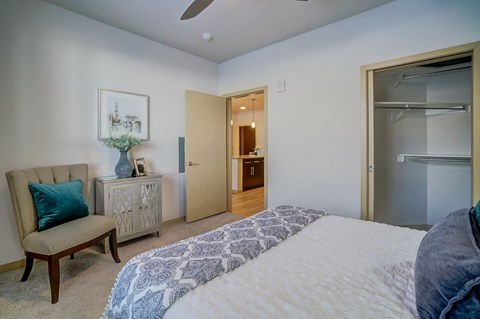 a bedroom with a bed and a door to a bathroom