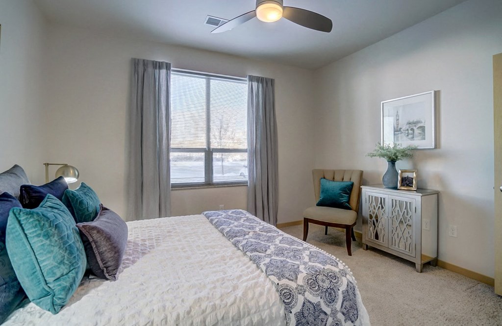 a bedroom with a large bed and a ceiling fan