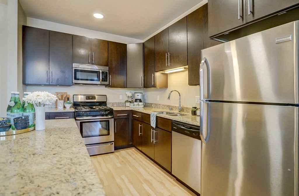 a kitchen with stainless steel appliances and wooden cabinets