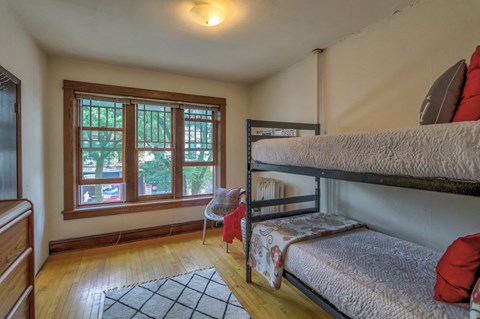 a bedroom with two bunk beds and a window