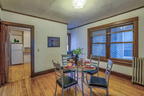 a dining room with a table and chairs and a large window