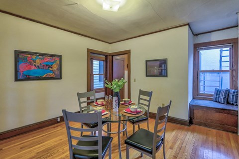 a dining room with a table and chairs