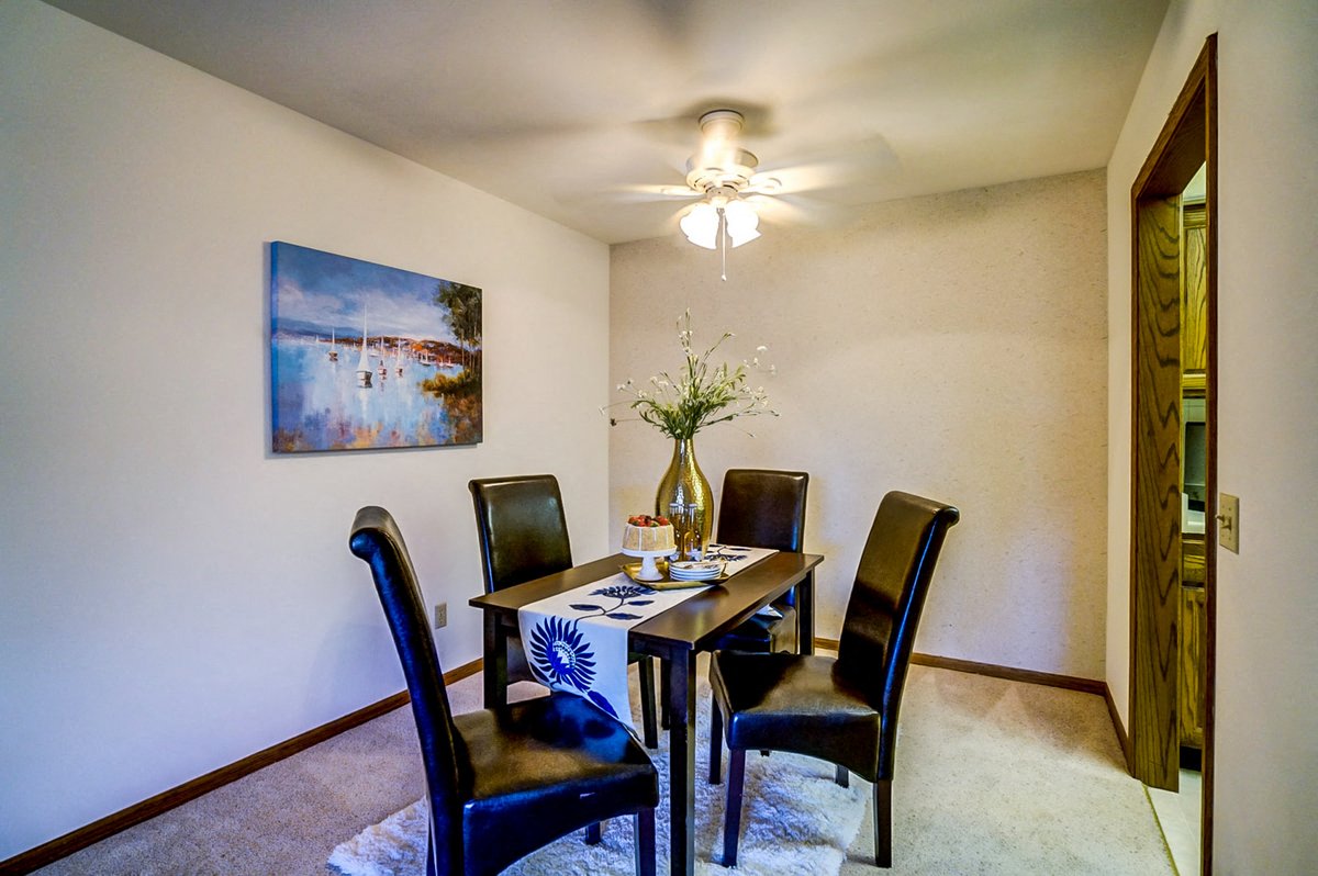 a dining room with a table and chairs