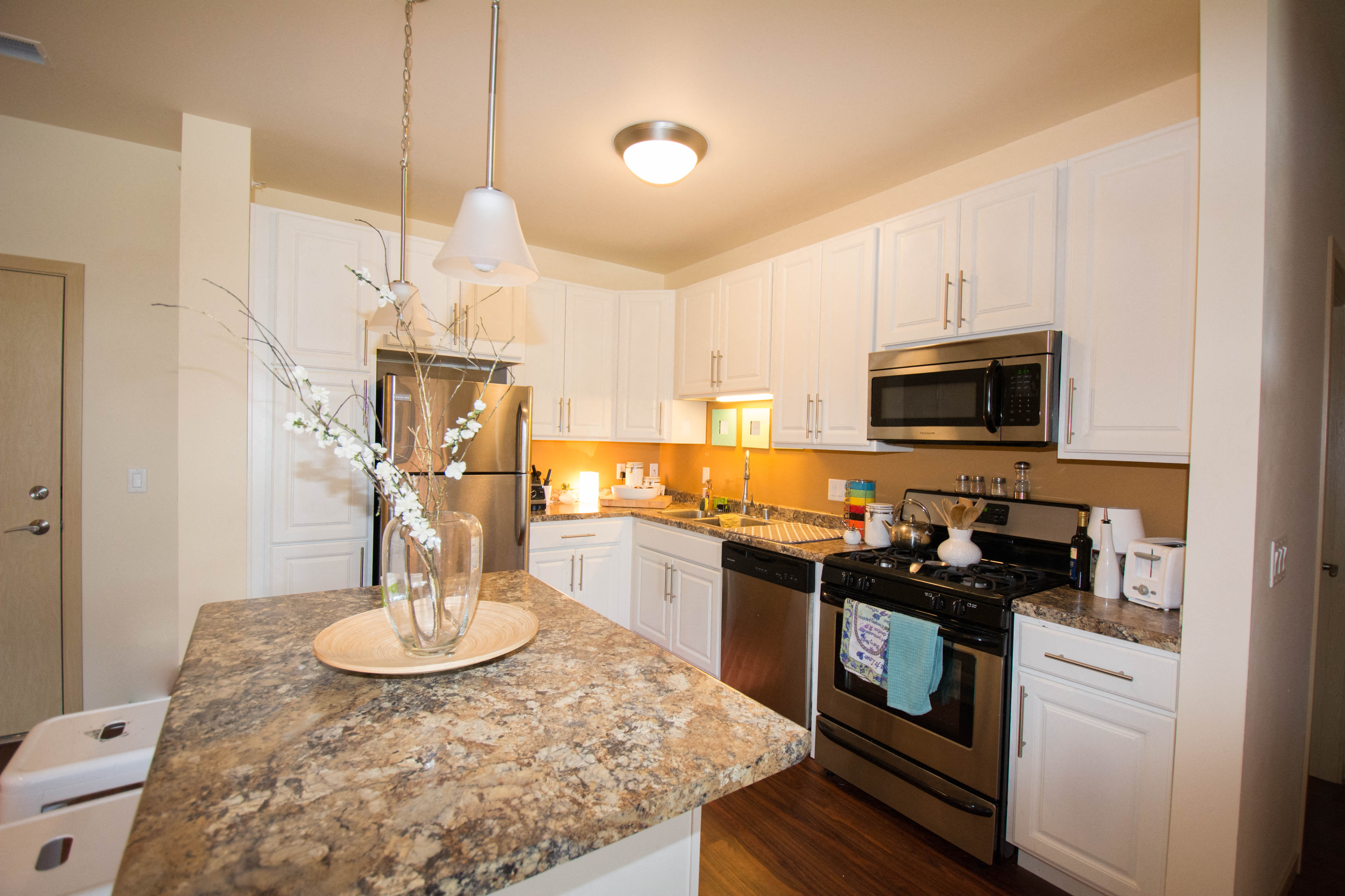 a kitchen with stainless steel appliances and granite counter tops