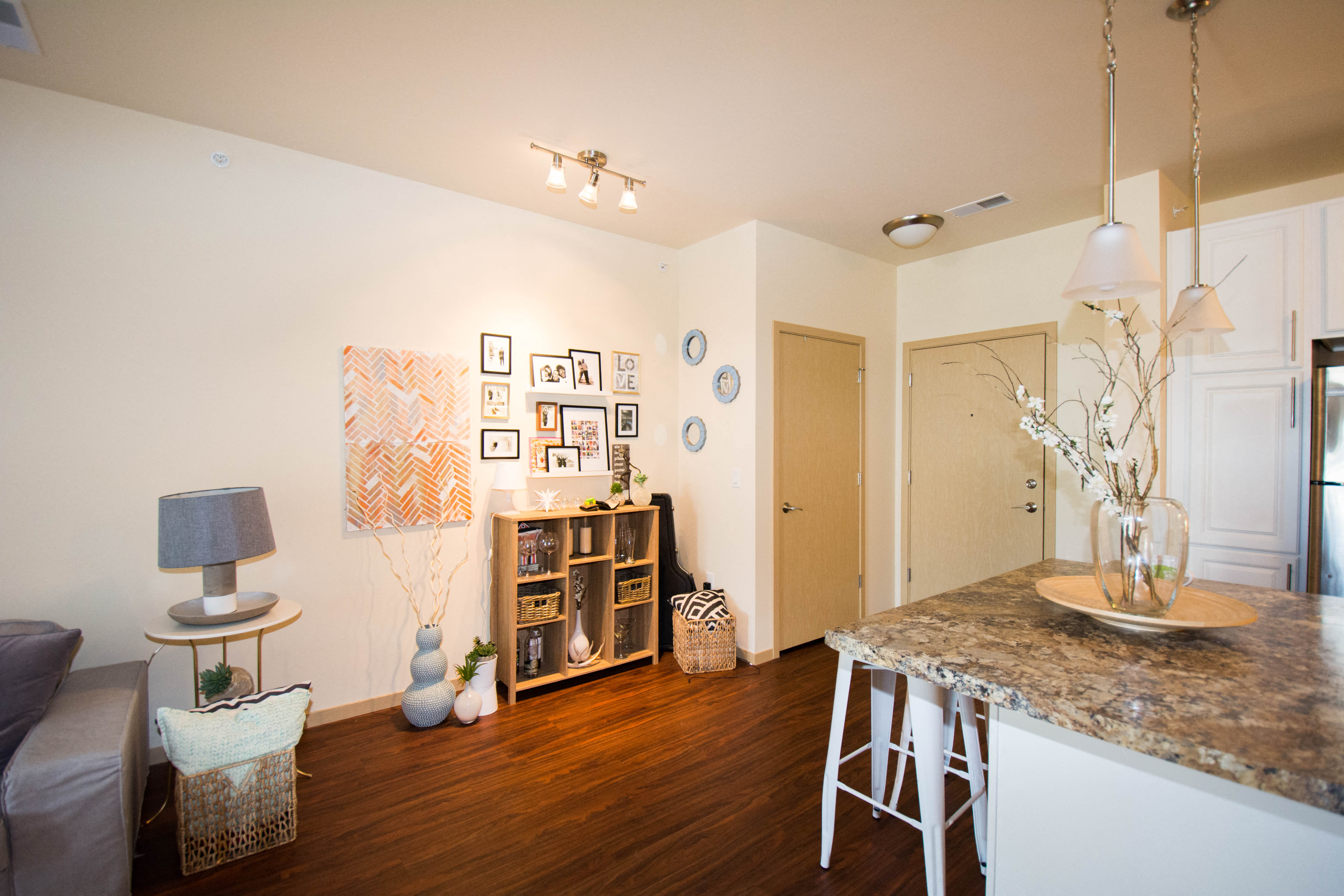 a living room with a dining room table and a kitchen