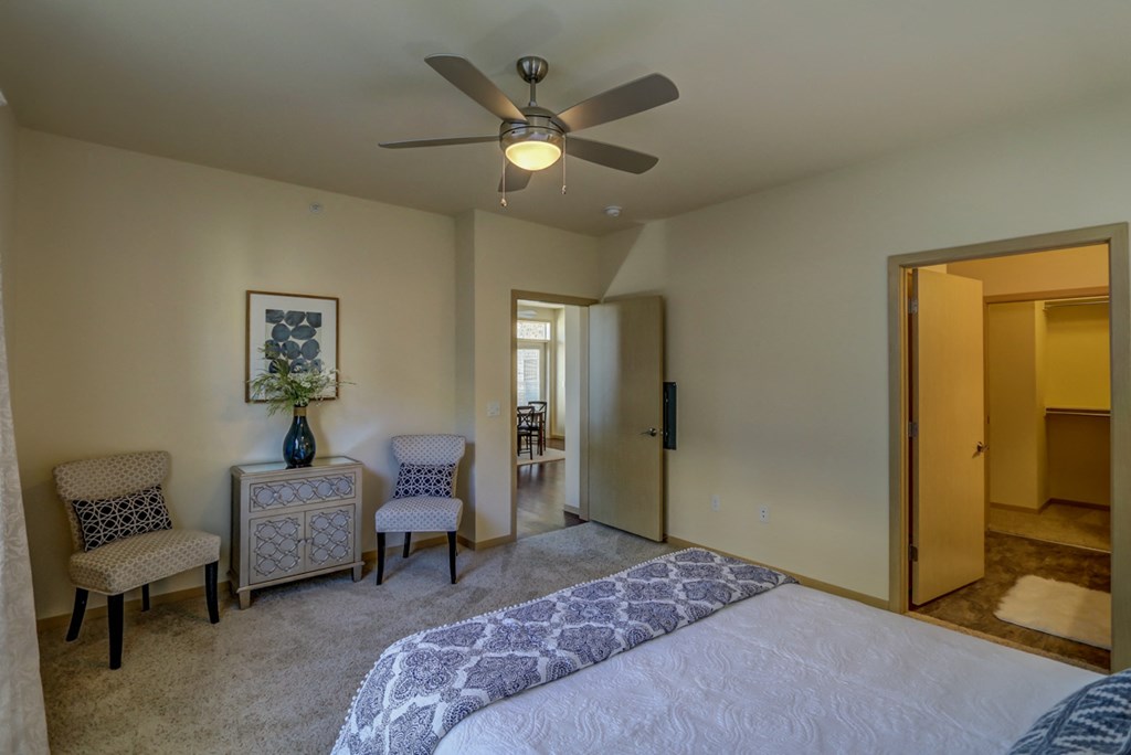 a bedroom with a large bed and a ceiling fan