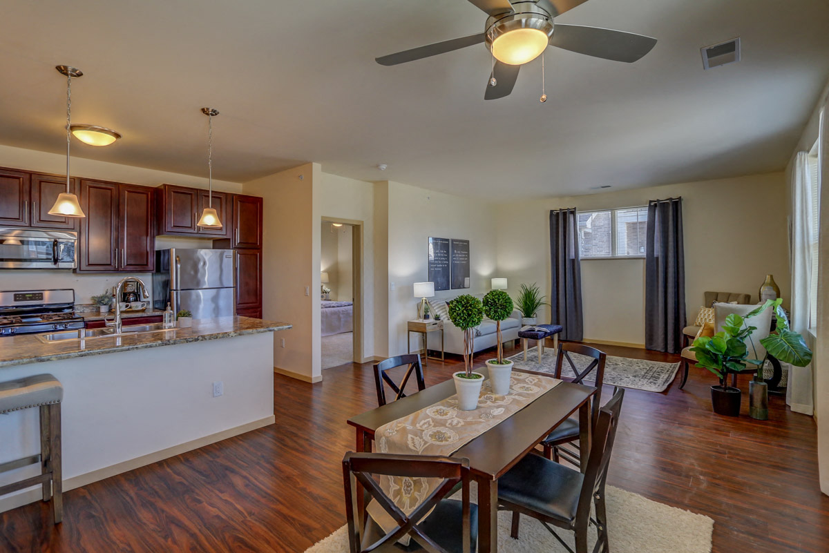 an open living room and kitchen with a dining room table
