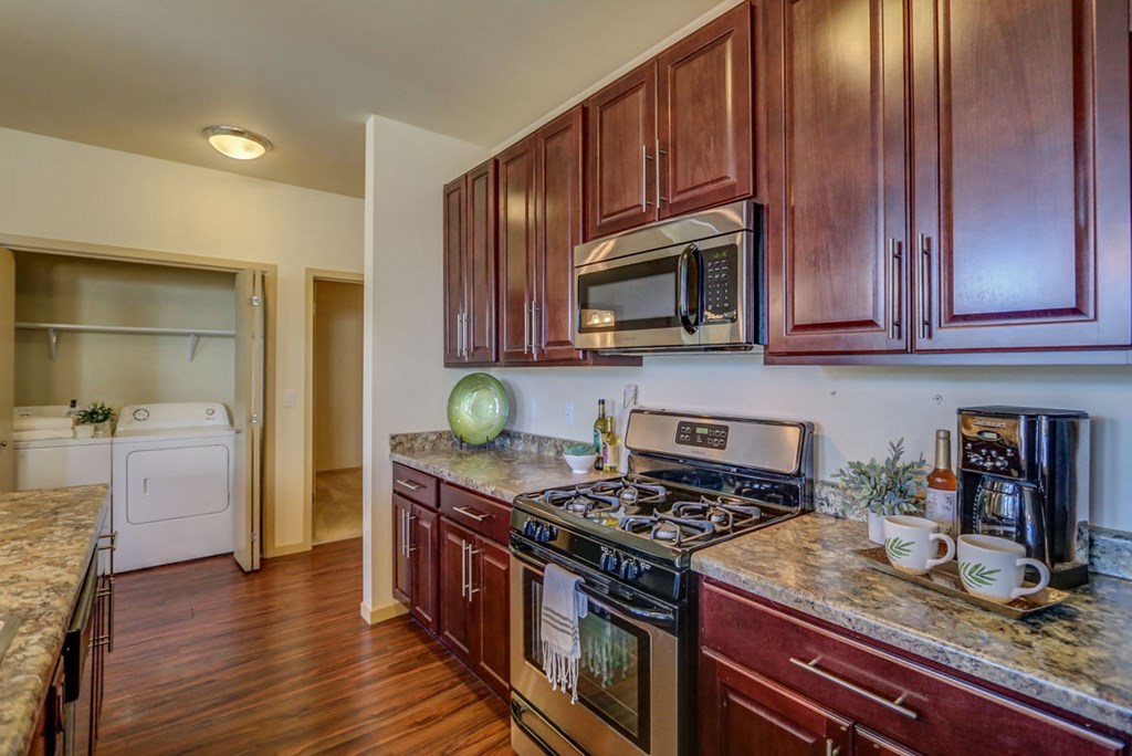 a kitchen with wooden cabinets and stainless steel appliances