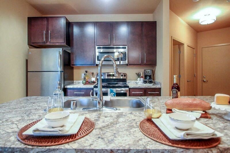 a kitchen with stainless steel appliances and a granite counter top