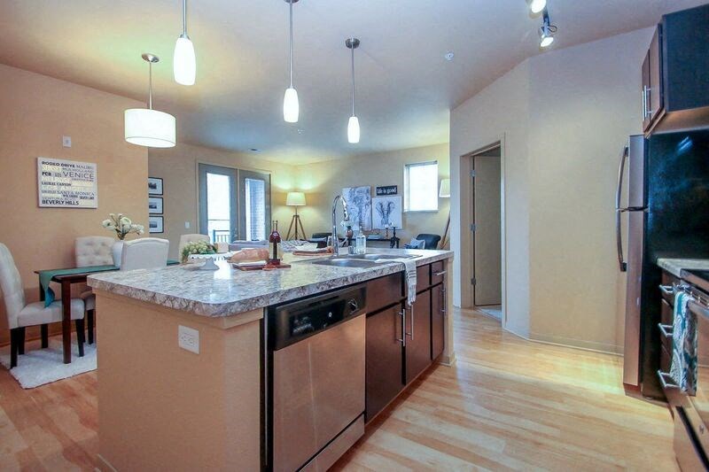a large kitchen with a sink and a counter top