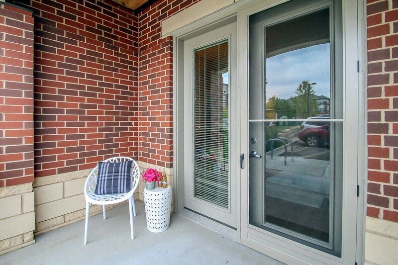 a chair sitting on a porch next to a door