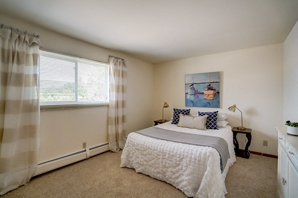 a bedroom with a bed and a window