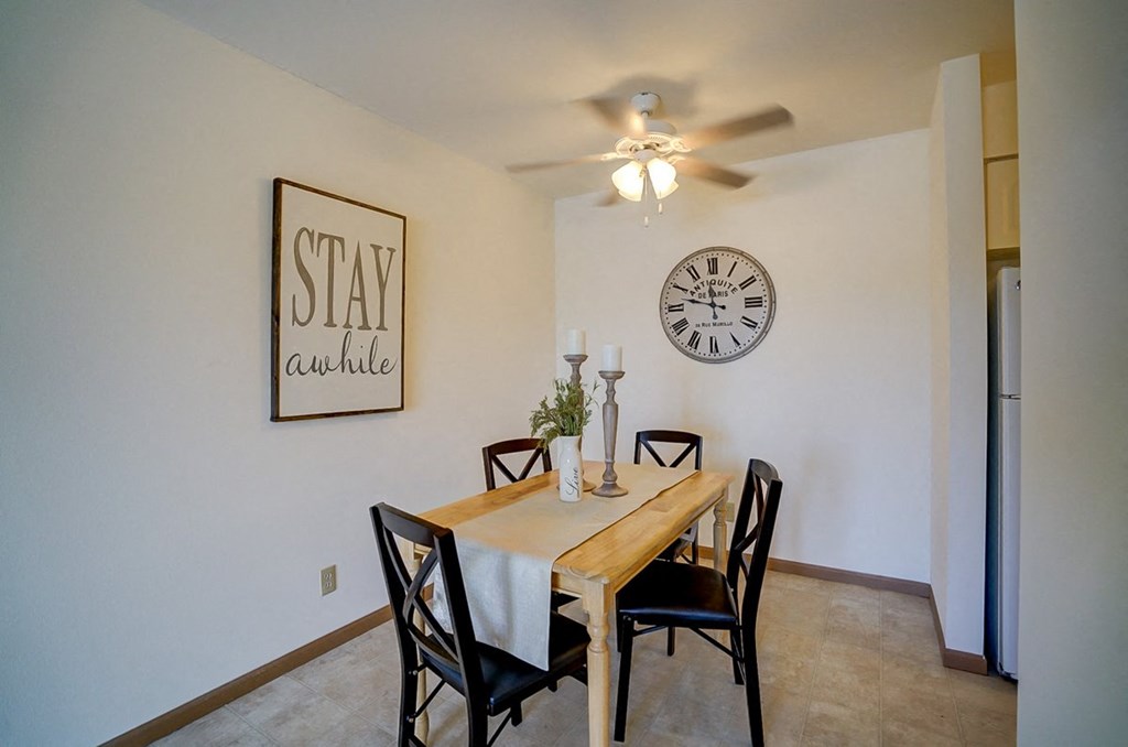 a dining room with a table and a clock on the wall