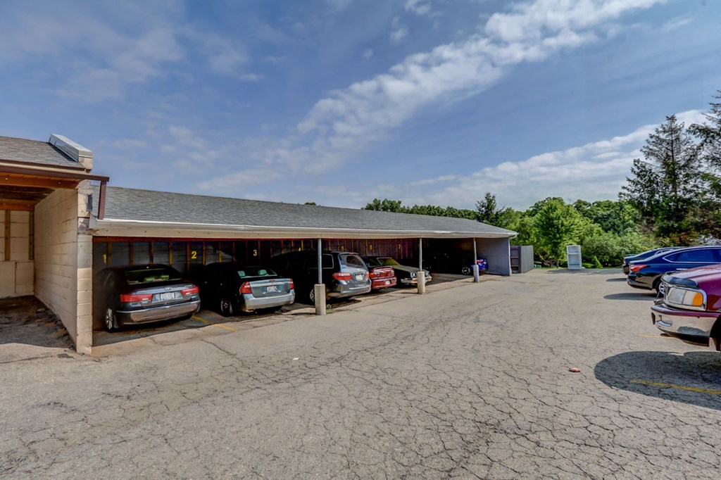 a parking lot with cars parked in front of a building