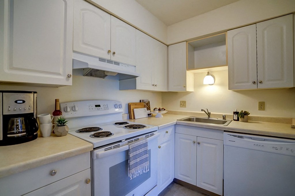 a kitchen with white appliances and white cabinets