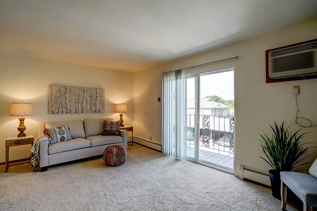 a living room with a couch and a sliding glass door