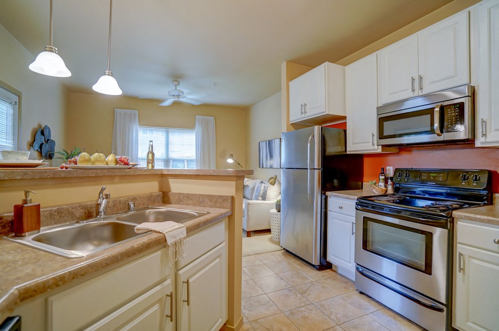 a kitchen with stainless steel appliances and white cabinets