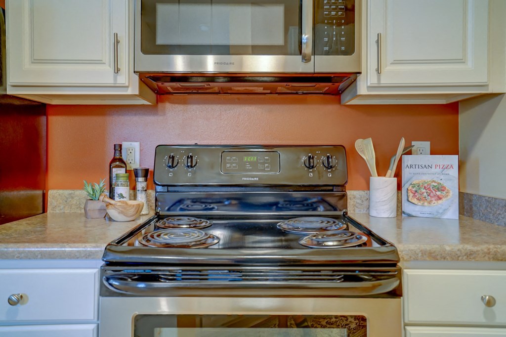 a kitchen with a stove and a microwave