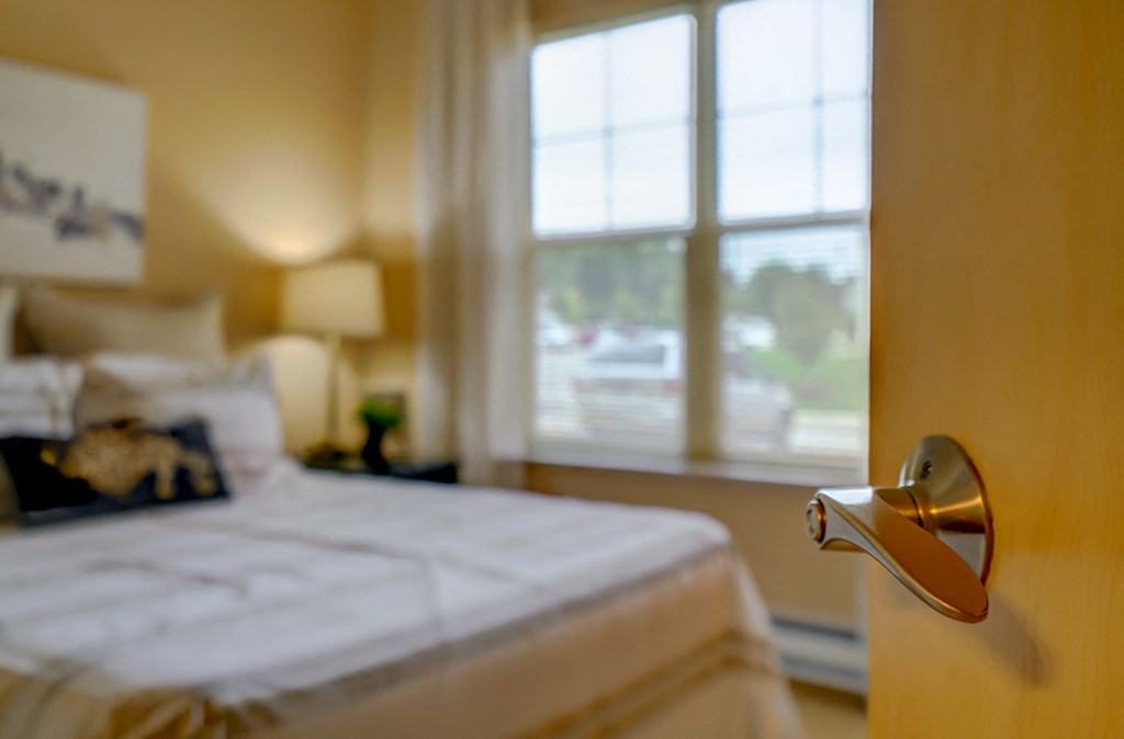 a bedroom with a bed and a door with a handle