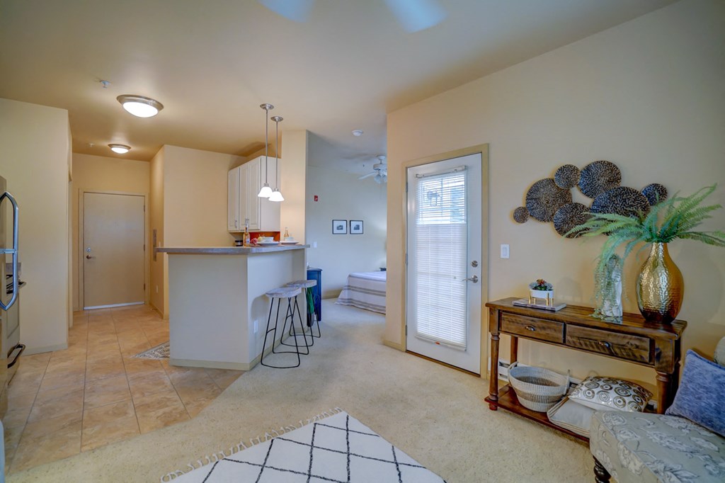 a kitchen with a bar and a living room with a couch