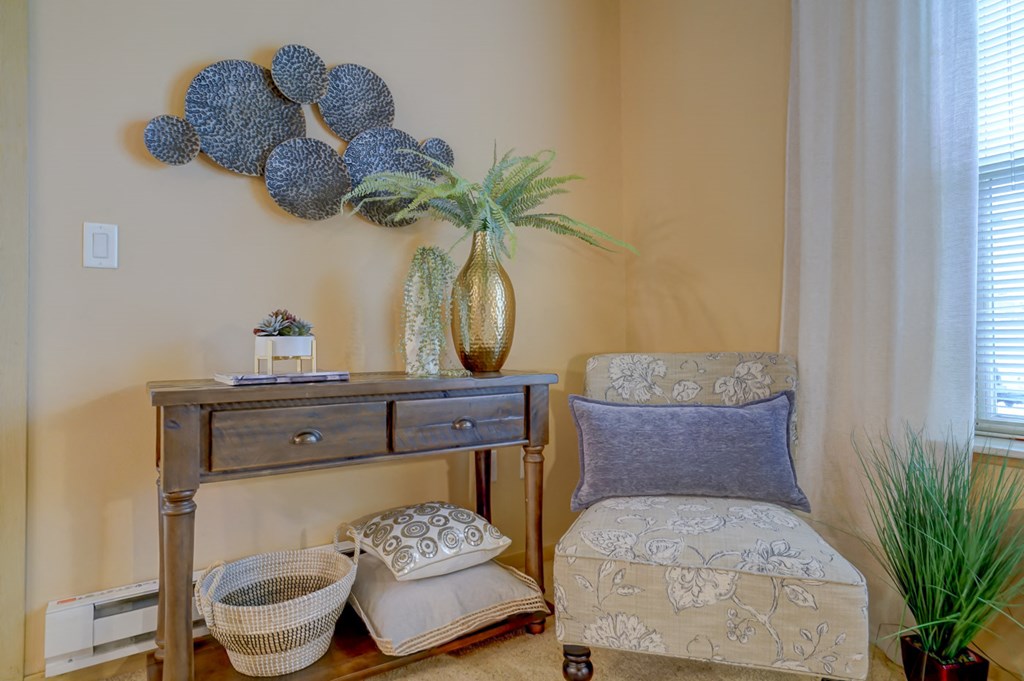 a seating area with a chair and a desk with spheres on the wall