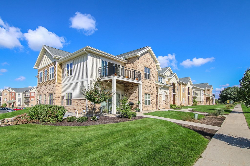 a row of houses with a sidewalk in front of them