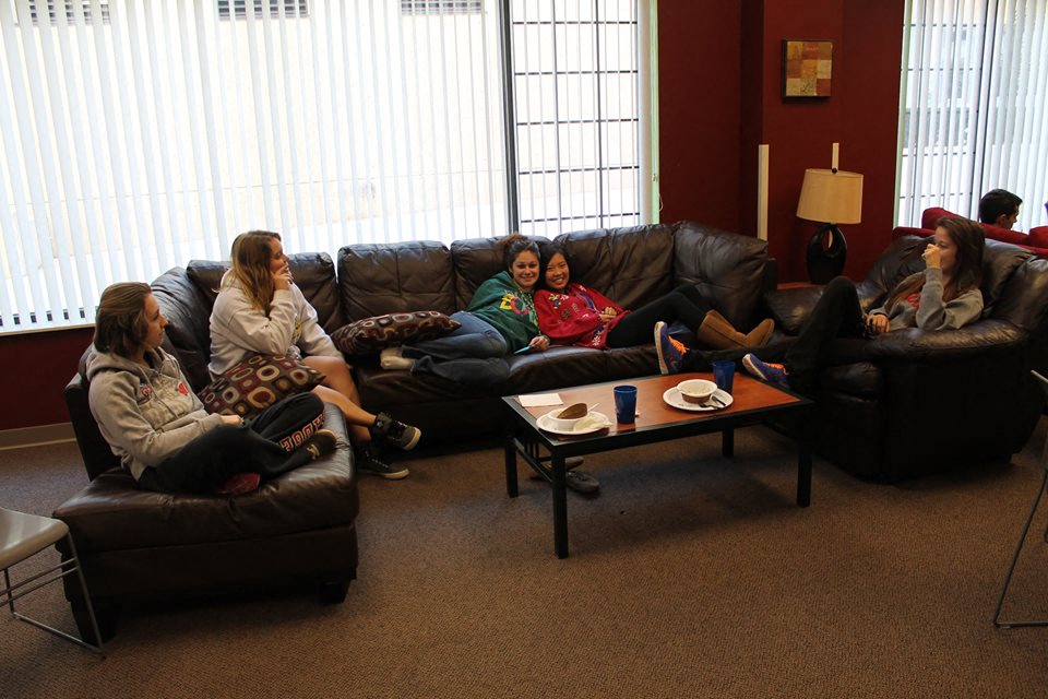 a group of people sitting on couches in a living room