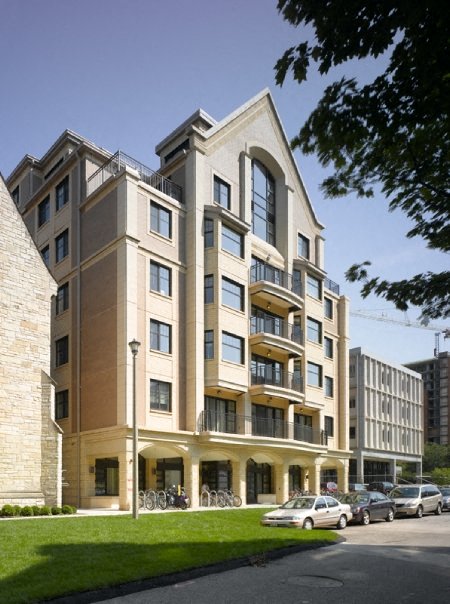 a large apartment building with cars parked in front of it