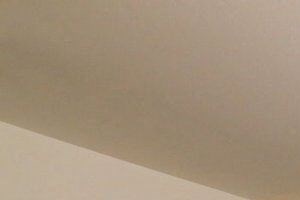 a bedroom with a bed and a dresser in it