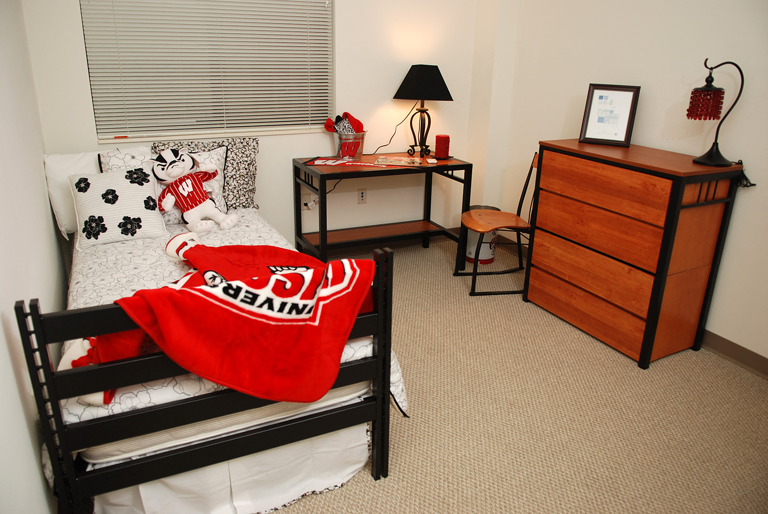a bedroom with a bed and a dresser in the corner