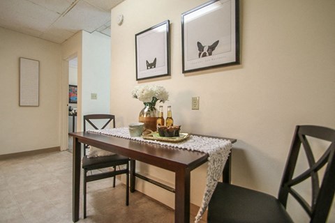 a dining room with a table and chairs