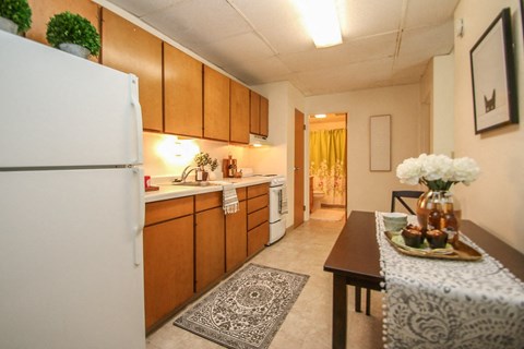 a kitchen with a table and a refrigerator