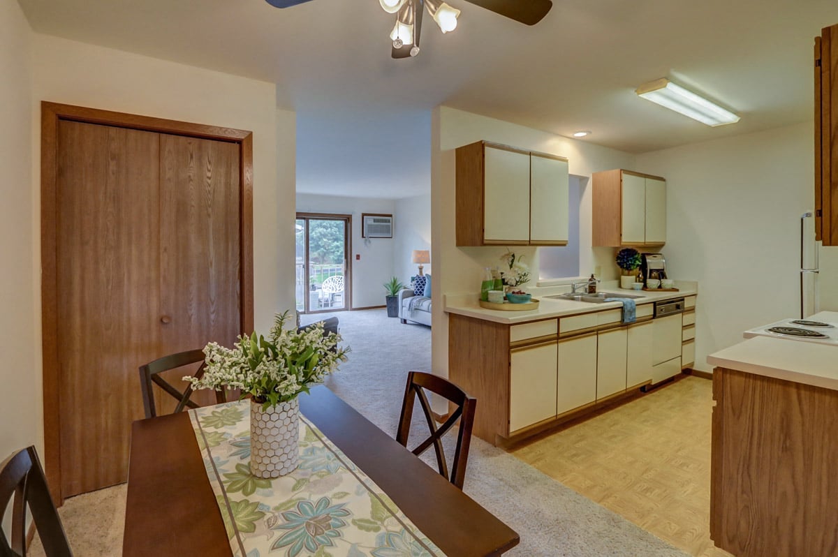 a kitchen and dining room with a table and chairs