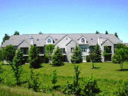 a large house with trees in the grass