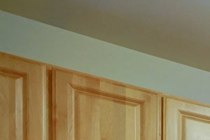 a kitchen with wooden cabinets and a stove and a sink