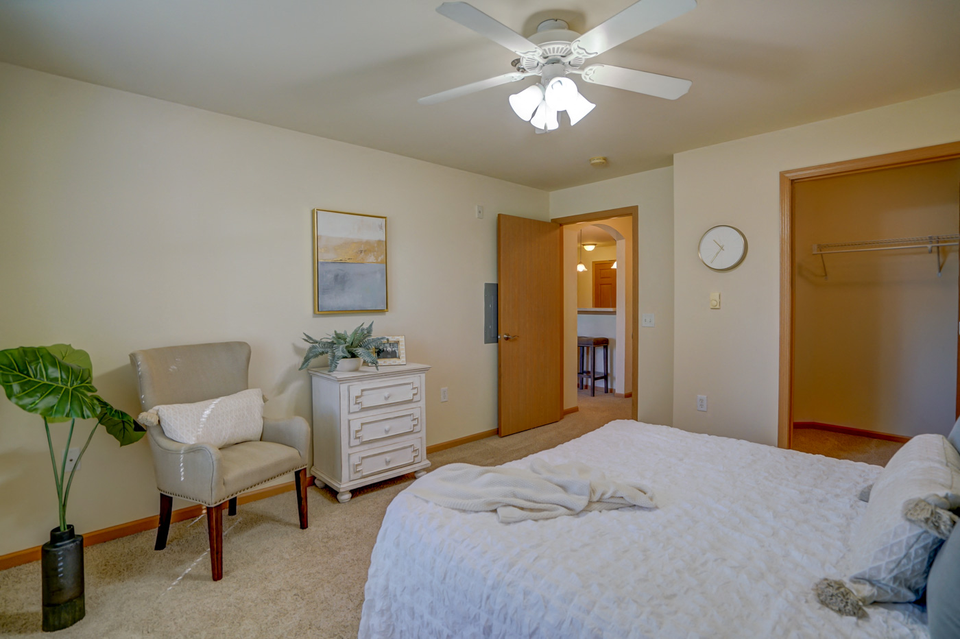 a bedroom with a large bed and a ceiling fan