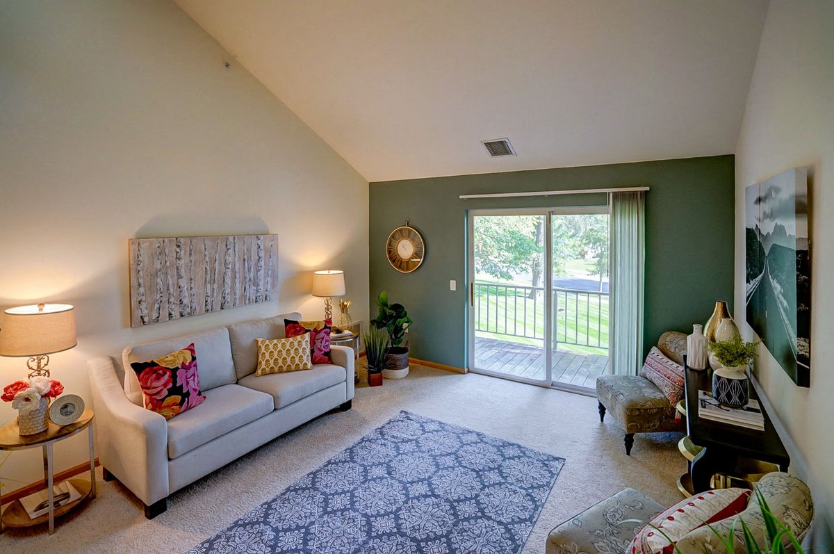 a living room with a couch and a sliding glass door